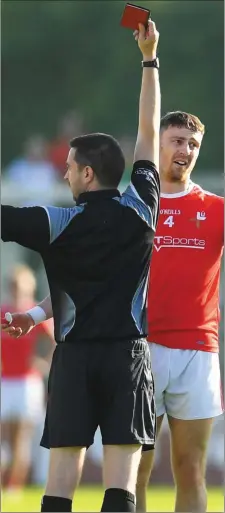  ??  ?? James Craven of Louth is shown a red card by referee Noel Mooney.