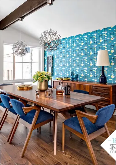  ??  ?? The retro-look wallpaper is a show-stopping focal point and inspired the use of blue and yellow throughout the open-concept space.
LEFT New metal pendant lights sourced by designer Marina Farrow illuminate the locally crafted dining table....