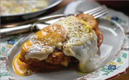  ?? CONTRIBUTE­D BY HENRI HOLLIS ?? The classic croque madame, a grilled cheese topped with bechamel and a sunny-side-up egg.