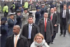  ?? ROBERT HANASHIRO, USA TODAY ?? Secret Service agents guard President Donald Trump’s motorcade. More than 1,000 agents have hit caps on salary.