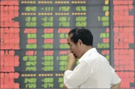  ?? PHOTO: REUTERS ?? An investor stands in front of an electronic board showing stock informatio­n at a brokerage house in Fuyang, Anhui province, China, yesterday.