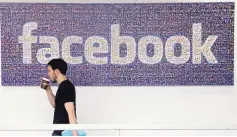  ?? JEFF CHIU/ASSOCIATED PRESS ?? A Facebook employee walks past a sign at Facebook headquarte­rs in Menlo Park, Calif., in 2013. The company issued a mea culpa Wednesday.