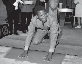  ?? THE ASSOCIATED PRESS FILE PHOTO
MATT SAYLES THE ASSOCIATED PRESS ?? Poitier places his hands in wet cement at Grauman’s Chinese Theater in Los Angeles on June 23, 1967. Three years earlier, in 1964, he became the first Black man to win an Academy Award for best actor.
Actor Sidney Poitier wasn’t just a star, he was a legend, a lion, an almost mythical figure in Black culture and the culture at large. He was Black royalty.