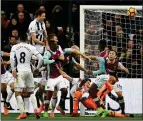  ??  ?? LATE SHOW: Jonny Evans heads against Gareth McAuley and into West Ham’s net