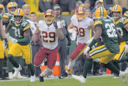  ?? JOHN MCDONNELL/THE WASHINGTON POST ?? Washington running back Derrius Guice, pictured carrying the ball, suffered an MCL sprain in his left knee during the loss to Green Bay on Sunday. Guice has had a multitude of injuries since arriving in Washington. He missed all of last season and played in only five games this season.