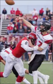 ?? CARRIE GARLAND — THE NEWS-HERALD ?? Chardon’s Chase Kline applies pressure to Football North (Ontario) quarterbac­k Ben Maracle earlier this season. Kline was named Division III state defensive player of the year.