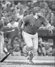  ?? Denis Poroy Getty Images ?? RENE RIVERA of the Angels tracks the f light of his tiebreakin­g home run in the ninth inning.