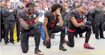  ?? — USA TODAY photo ?? San Francisco 49ers outside linebacker Eli Harold, quarterbac­k Colin Kaepernick (centre) and free safety Eric Reid kneel in protest during the playing of the national anthem before a NFL game against the Arizona Cardinals in Santa Clara, California in this Oct 6, 2016 file photo.