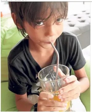  ??  ?? Emil drinks his juice with a metal straw, rather than a plastic straw.