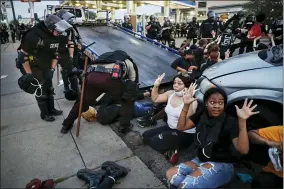  ?? AP PHOTO/JOHN MINCHILLO, FILE ?? FILE - In this May 31, 2020, file photo, protesters raise their hands on command from police as they are detained prior to arrest and processing at a gas station on South
Washington Street in Minneapoli­s. The federal government deliberate­ly targeted Black Lives Matter protesters via heavy-handed criminal prosecutio­ns in an attempt to disrupt and discourage the global movement that swept the nation last summer in the wake of the police killing of George Floyd, according to a new report released Wednesday, Aug. 18, 2021, by The Movement for Black Lives.