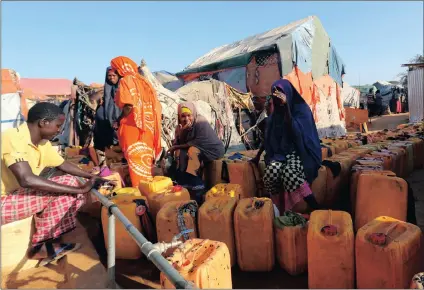  ?? PICTURE: REUTERS ?? Internally displaced Somalis arrange containers to collect water from a tap at the Al-cadaala camp in the capital Mogadishu on Monday.