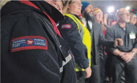  ?? ADRIAN WYLD THE CANADIAN PRESS ?? Canada Post employees stand with NDP Leader Jagmeet Singh for a group photo on Friday in Ottawa.