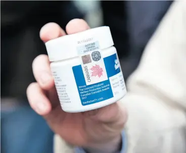  ?? MARTIN OUELLET-DIOTTE / AFP / GETTY IMAGES ?? A customer shows a San Rafael ’71 marijuana product that he bought after entering a cannabis store Wednesday in Montreal on the first day of legalizati­on.