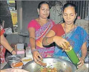  ?? M KRISHNA/HT PHOTO ?? A tribal woman prepares bamboo chicken.