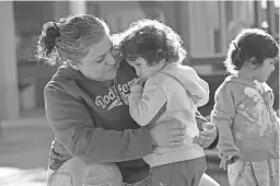  ?? PROVIDED BY A NEW LEAF ?? A woman comforts a child at A New Leaf’s Phoenix Day Janis Merrill Education Center in south Phoenix.