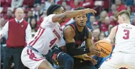  ?? ANDY MANIS/AP ?? Maryland’s Jahmir Young, right, maneuvers against Wisconsin’s Kamari McGee during the first half of a game in Madison, Wisconsin, on Tuesday.