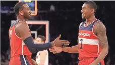  ?? BRAD PENNER, USA TODAY SPORTS ?? With John Wall, left, and Bradley Beal on court, the Wizards scored 112.9 points per 100 possession­s last season.