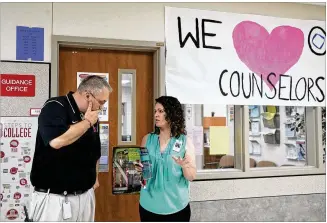  ?? LYNDA M. GONZALEZ / AMERICAN-STATESMAN ?? School counselor Deanna Baker meets with administra­tor Bryon Ellison outside the guidance office at Vista Ridge High School in Cedar Park last week. “The mental health part of the school counselor role is so crucial to the well-being of an entire school,” Baker said.