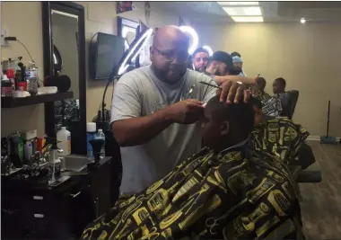  ?? KEVIN MARTIN — THE MORNING JOURNAL ?? Barber Angel Ayala of The Spot Barbershop, 1828 E. 28th St. in Lorain gives free back-to-school haircuts Aug. 18 for Lorain youth. The initiative was in collaborat­ion with El Centro, the Mexican Mutual Society and support from a number of community organizati­ons.