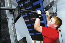  ?? FRED SQUILLANTE / COLUMBUS DISPATCH ?? Eli Sertell, 9, of West Liberty climbs a wall during ninja summer camp at Movement Lab Ohio.