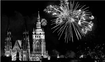  ??  ?? Fireworks explode over the towers of the St Vitus Cathedral at Prague Castle to mark the first day of the new year. — Reuters photo