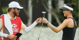  ?? ANDREW REDINGTON, GETTY IMAGES ?? Golfer Michelle Wie reacts with her caddie after a birdie on the 17th hole during the first round of the HSBC Women’s Champions in Singapore on Thursday.