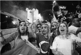  ?? JEFF J MITCHELL GETTY IMAGES ?? Recep Tayyip Erdogan’s supporters celebrate outside the AK party headquarte­rs on Sunday in Istanbul, Turkey. Erdogan claimed victory in the election, but the opposition had not yet conceded.
