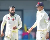  ??  ?? England’s Adil Rashid (L) speaks with captain Joe Root during the second day of the third Test against Sri Lanka on Saturday