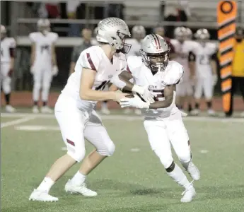  ?? Travis Simpson/Special to Siloam Sunday ?? Siloam Springs quarterbac­k Hunter Talley hands the ball off to running back Jeff Phizema during Friday’s game at Russellvil­le. Phizema rushed for more than 200 yards including the go-ahead score with 41 seconds left in a 50-47 Panthers victory.