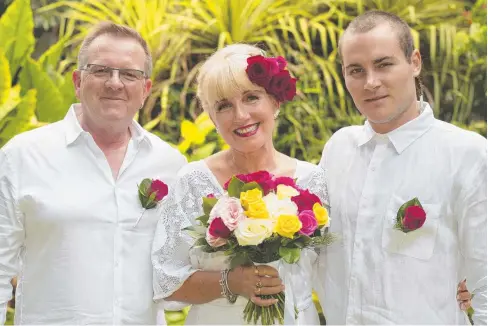  ?? Pictures: MIKE WATT ?? HAPPY OCCASION: Former Cairns designer Susan Connell, with partner Mark Kent (left) and son Jesse Connell, chose the Cairns Botanic Gardens as the venue for her commitment ceremony.