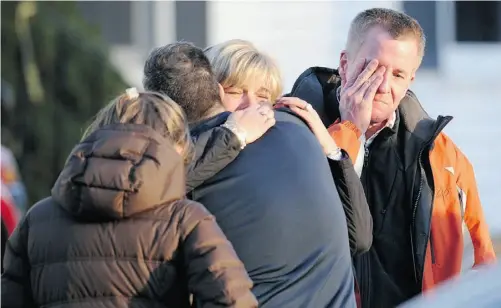  ?? DON EMERT /AFP/ Getty Images ?? Grief filled the community and the nation Friday in the aftermath of a school shooting at a Connecticu­t elementary school. We need to ask why so many young men are so alienated and afflicted that they strike out in such terrible fury, Paula Simons...