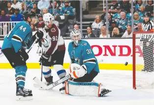  ?? JOSIE LEPE/AP ?? Sharks defenceman Marc-Edouard Vlasic looks on as the Avs’ Gabriel Landeskog scores on goalie Martin Jones in Game 2 of their second-round series on Sunday at the SAP Center in San Jose.