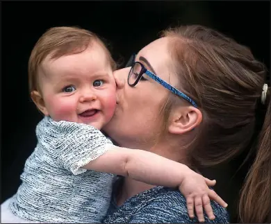  ??  ?? Bouncing back: Ten-month-old Amy, with her mother Claire Martin, survived two operations