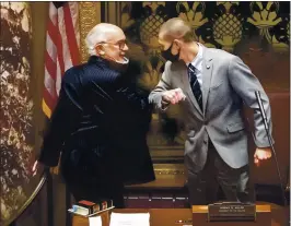  ?? GLEN STUBBE — STAR TRIBUNE VIA AP ?? Minnesota state Senate President Jeremy Miller, R-winona, gives Sen. David Tomassoni, Dfl-chisholm, an elbow bump while not wearing his mask Nov. 12.