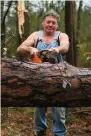  ?? The Associated Press ?? n Mitch Hendry cuts through fallen trees Wednesday on his property after a tornado came through on St. Patrick’s Day near Strengthfo­rd Cooley Road in Wayne County, Miss.