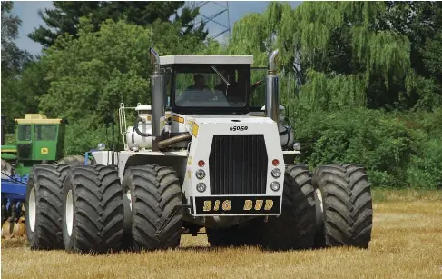  ??  ?? Got 12 cylinders, uses ’em all! The dual stacks tell you this is a vee-type engine, but you don’t see many V12 tractors out there. The Big Bud 650/50 shown here belongs to Larry Addleman and it’s currently the only one of the two ag units still in the States, the other having been exported to Australia years ago. Addleman bought the tractor from Ron Harmon at Big Equipment 16 years ago. Harmon is the guy who put Big Bud on the map, and when it failed in the midst of the Twin-disc fiasco, he created Big Equipment to support the 518 Big Buds that were built. This one had been used in Colorado, then sold it back to Harmon. Harmon refurbishe­d it and sold to Addleman, who uses it on his large Southern Michigan farm. Addleman is a well-known Big Budd collector, with five in his stable. Besides the 650/50 he has a 525/50, 400/30, 400/20, and a 450, which is the last Big Bud tractor ever built.