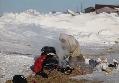  ?? Photo by RB Smith ?? PREPARING A MEAL— Ramey Smyth heats up water in preparatio­n for a warm meal for his dog team, in Shaktoolik on Sunday, March 13.