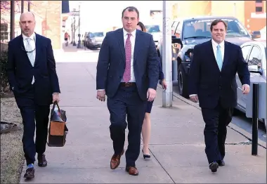  ?? NWA Democrat-Gazette/ANDY SHUPE ?? Former state Sen. Jon Woods (right) walks Tuesday with his attorney, Patrick Benca (far left), and others from the Benca Law Firm to the John Paul Hammerschm­idt Federal Building in Fayettevil­le.