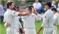  ?? AFP ?? New Zealand’s Colin de Grandhomme (left) celebrates wicket of England’s Dawid Malan with teammate Jeet Raval (right). —