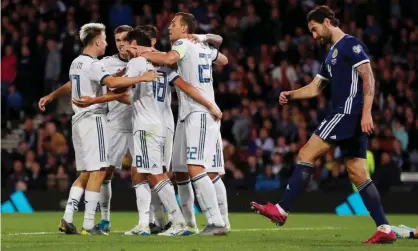  ??  ?? Russia celebrate the winning goal as Charlie Mulgrew cuts a dejected figure. Photograph: Lee Smith/Action Images via Reuters