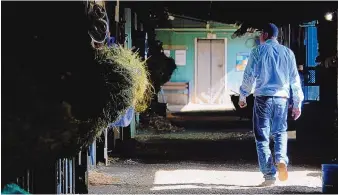  ?? ASHLEY LANDIS/ASSOCIATED PRESS ?? Tim Yakteen walks in his barn at Santa Anita Park on April 25 in Arcadia, Calif. He will saddle two horses — Messier and Taiba, both formerly trained by Bob Baffert — for Saturday’s Kentucky Derby.