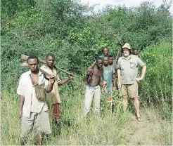  ??  ?? Author with the captured poachers.