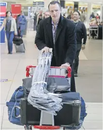  ?? GAVIN YOUNG ?? Dion Phaneuf checks in at Calgary Internatio­nal Airport after being traded to the Ottawa Senators on Tuesday. Phaneuf was headed to Detroit, where the Senators play on Wednesday night.