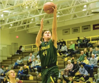  ?? APRIL GAMIZ/THE MORNING CALL PHOTOS ?? Emmaus’ Will Barber scores his first basket of the night in front of Bethlehem Catholic’s Jeremy Fyrer on Wednesday night in Bethlehem.