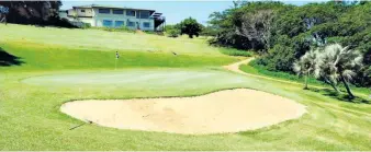  ?? ?? The new bunker in front of the final green, with the clubhouse overlookin­g