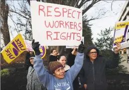  ?? Erik Trautmann / Hearst Connecticu­t Media ?? Dozens of janitors, community activists and union members protest on Nov. 26 outside 40 Richards Ave. in Norwalk to demand the building’s new owners reinstate five office cleaners who lost the jobs on Halloween.