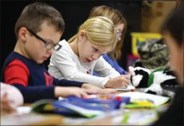  ?? (River Valley Democrat-Gazette/Hank Layton) ?? Madelyn Burns (center) and other first-graders complete Gifted and Talented Enrichment coursework Friday in Kimberly Watkins’ classroom at Fairview Elementary School in Fort Smith. The school was one of eight in the district that maintained or exceeded prepandemi­c index grades for the 2021-2022 academic year. Go to nwaonline.com/221120Dail­y/ for today’s photo gallery.