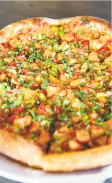  ?? Photos by Brittany Hosea- Small / Special to The Chronicle ?? The chicken tikka pizza shows the halal fusion at Mirchi Cafe.