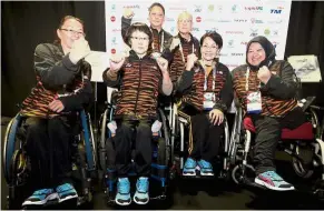  ??  ?? Good show: The table tennis squad of (from left) Chow Mei Hsia, Tan Kee Chok, Chung Sow Fun and Azila Alias with coaches (standing) Lim Kong Peng and Ng Kong celebrate their bronze achievemen­t.