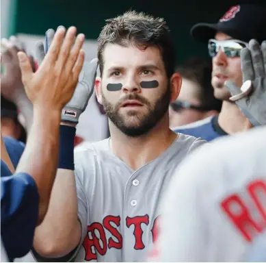  ?? John Minchillo, AP file) (Photo by ?? Boston Red Sox's Mitch Moreland, a former Mississipp­i State player, celebrates in the dugout after hitting a three-run home run last season. Moreland is remaining with the Red Sox, agreeing to a $13 million, two-year contract.